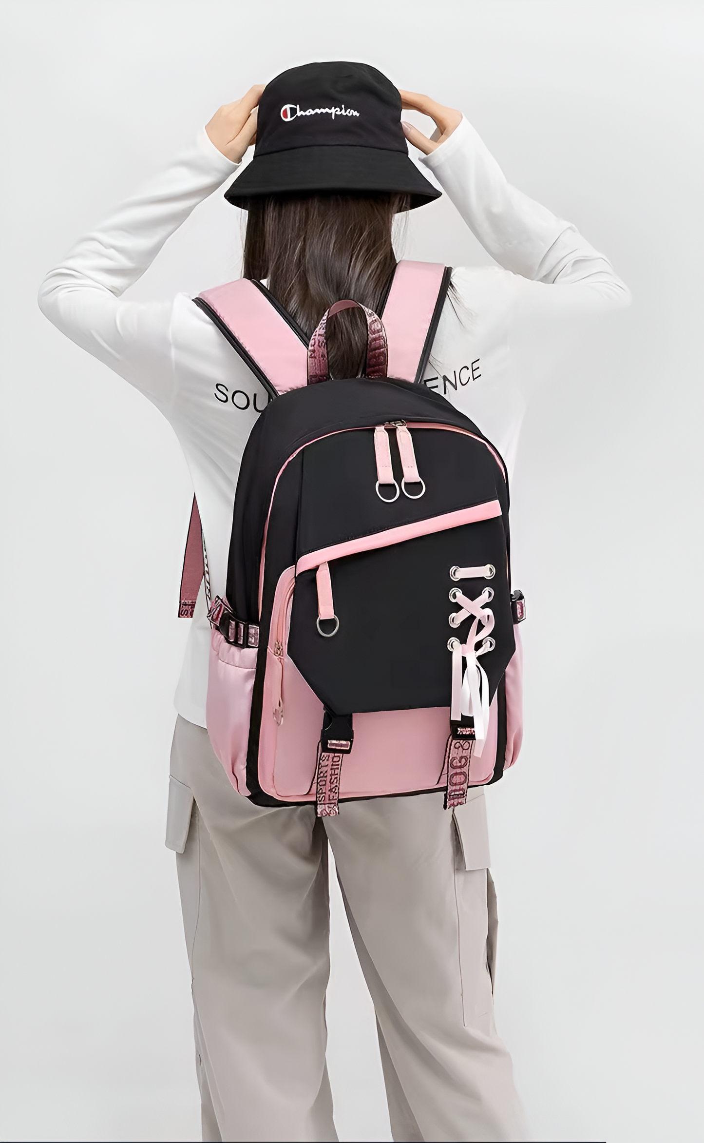 Person wearing a black and pink backpack with a white background
