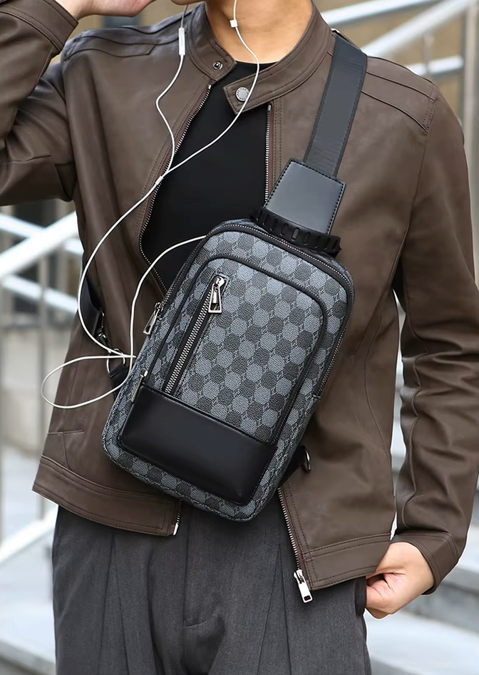 Person wearing a brown jacket with a patterned crossbody bag