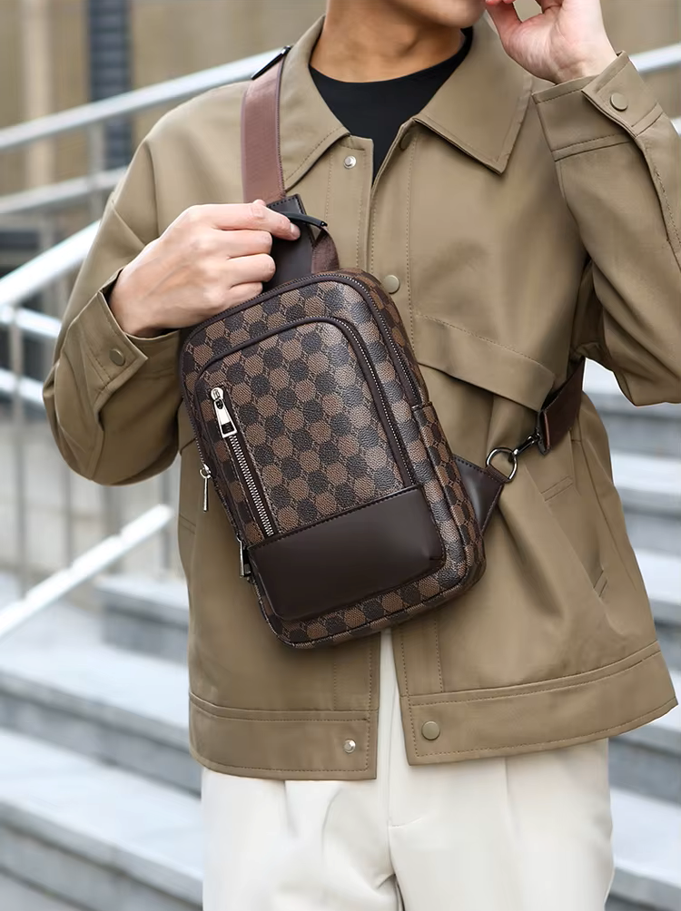 Person wearing a brown patterned crossbody bag outdoors