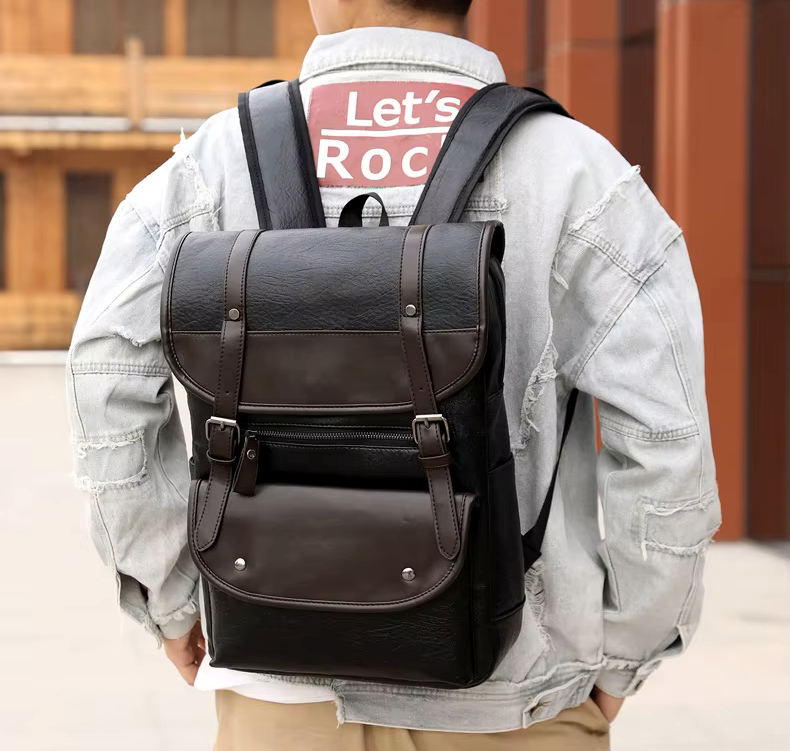 Person wearing a black leather backpack with a blurred background