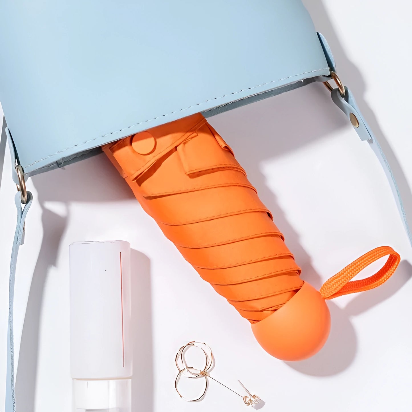 Orange umbrella with a light blue handle on a white background