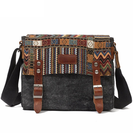 Multicolored patterned bag with dark gray base and brown leather straps on a white background