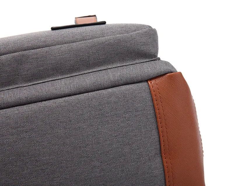 Gray bag with brown leather strap on a white background