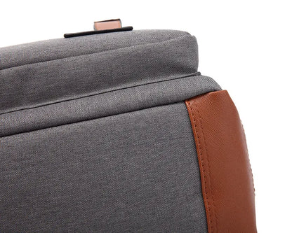Gray bag with brown leather strap on a white background