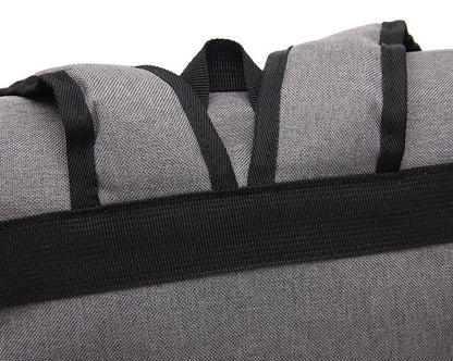 Gray duffel bag with black straps on a white background
