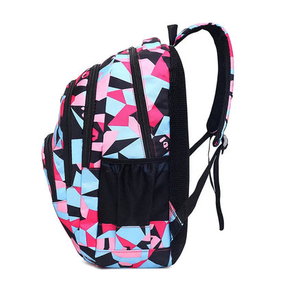 Backpack with geometric pink, blue, and black pattern on a white background