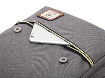 Gray backpack with a zipper pocket containing a smartphone