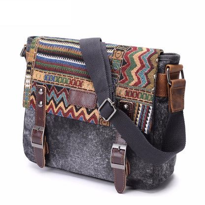 Multicolored patterned bag with gray base and brown leather straps on a white background