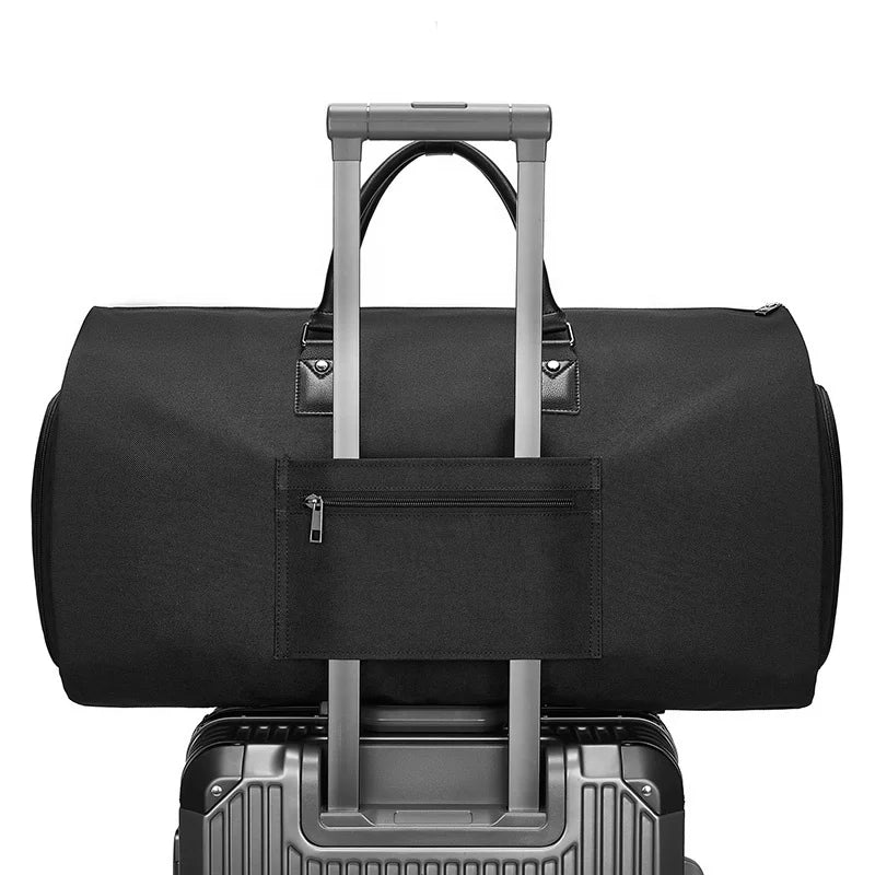Black duffel bag with wheels on top of a suitcase