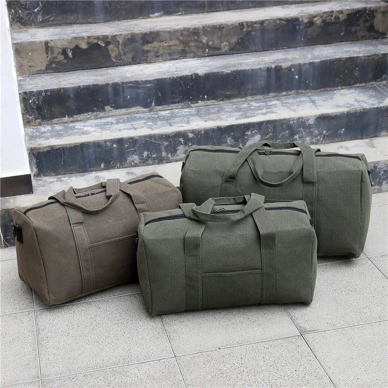 Three green duffel bags on a stone floor with steps in the background