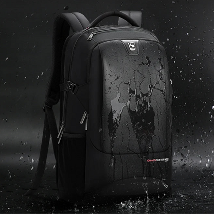 Black backpack with water splashes on a dark background, emphasizing waterproof material.