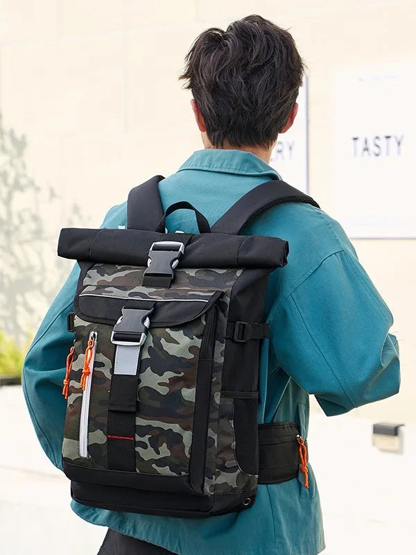 Person wearing a camouflage backpack with black straps in an outdoor setting