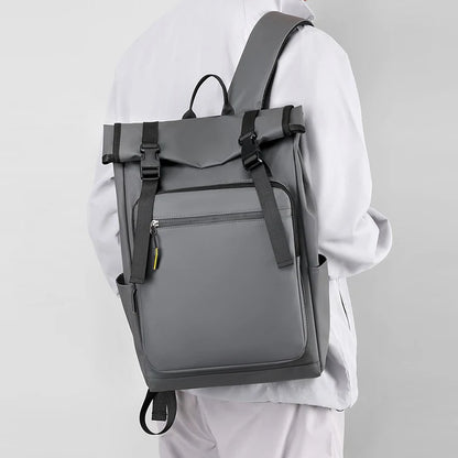 Person wearing a gray backpack on a plain background