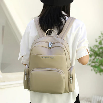 Person wearing a beige backpack with a blurred background