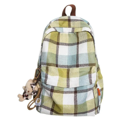 Plaid patterned backpack with a giraffe keychain on a white background