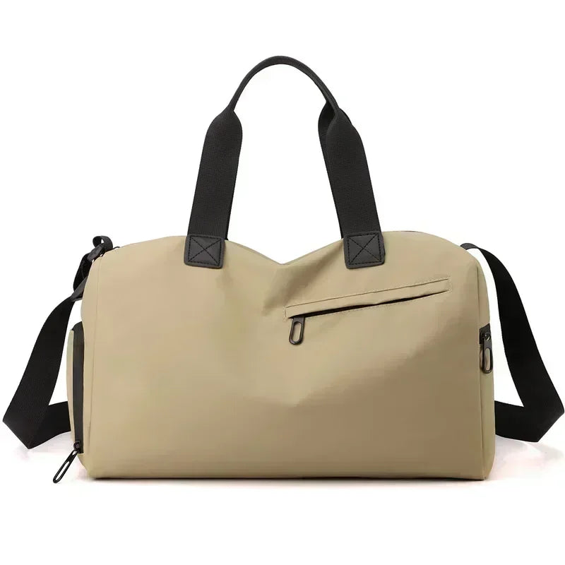 Beige duffel bag with black straps on a white background