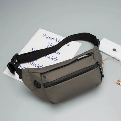 Gray waist bag with black strap on a light gray background