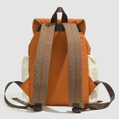 Orange and beige backpack with brown straps on a light gray background