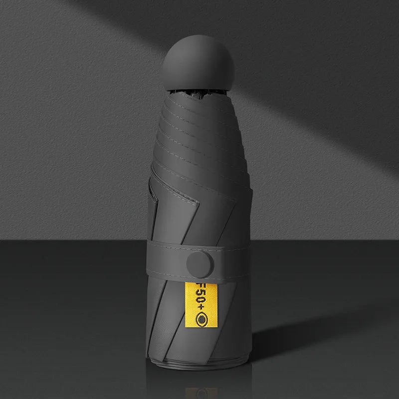 Gray handheld device with a yellow label on a dark background