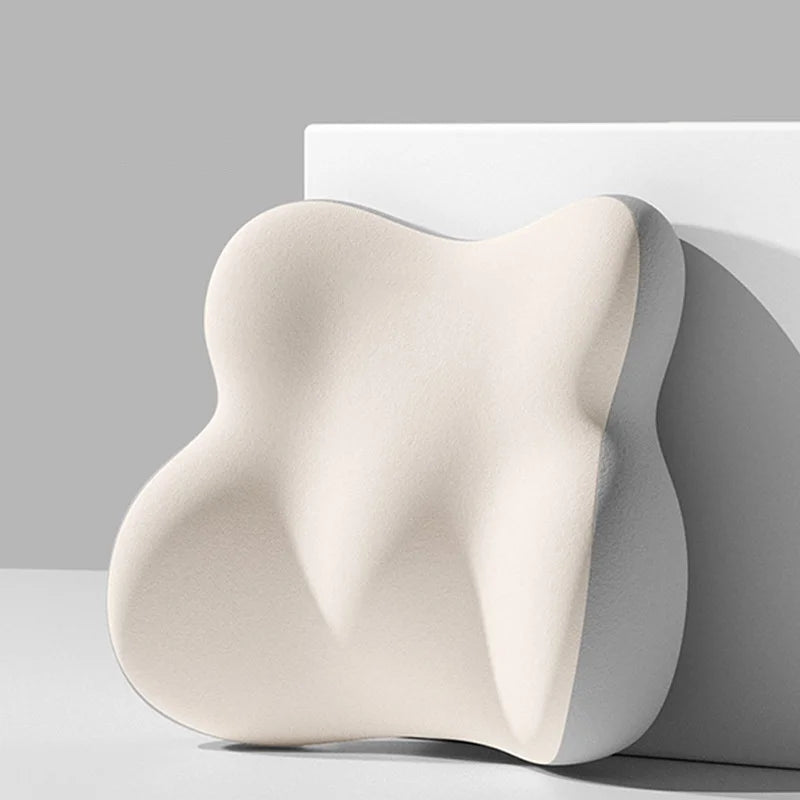 Beige ergonomic chair pad on a white surface with a gray background