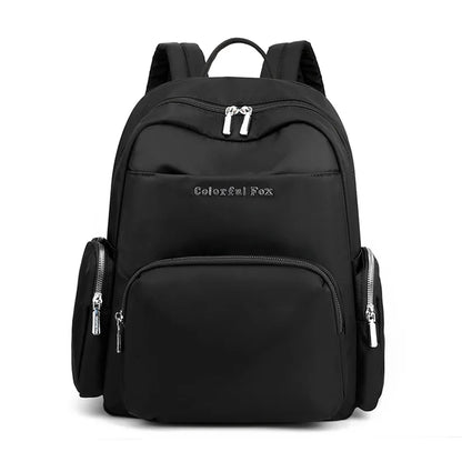 Black backpack with multiple pockets and zippers on a white background