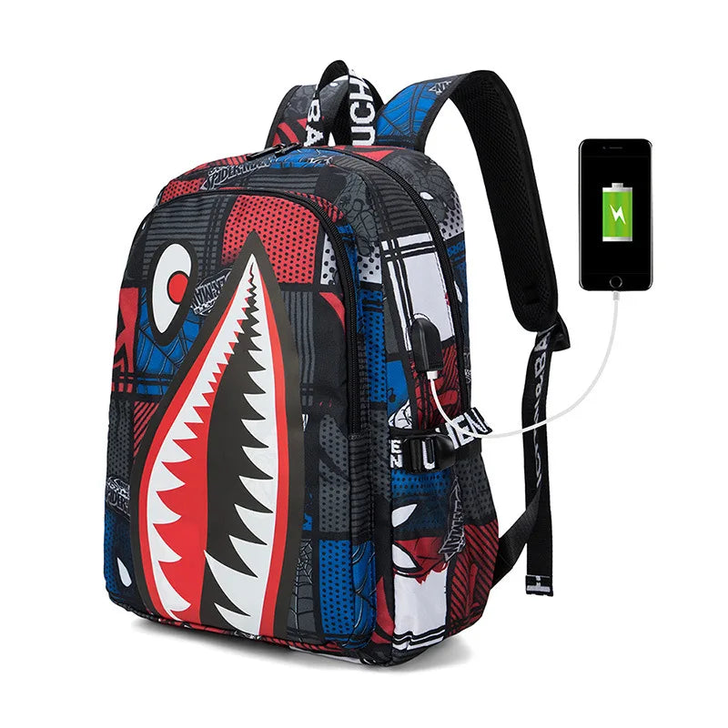 Colorful shark-mouth backpack with charging cable and phone on a white background