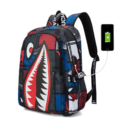 Colorful shark-mouth backpack with charging cable and phone on a white background