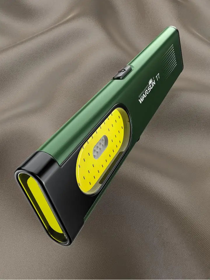 Green and yellow flashlight with 'Warson' branding on a brown fabric background