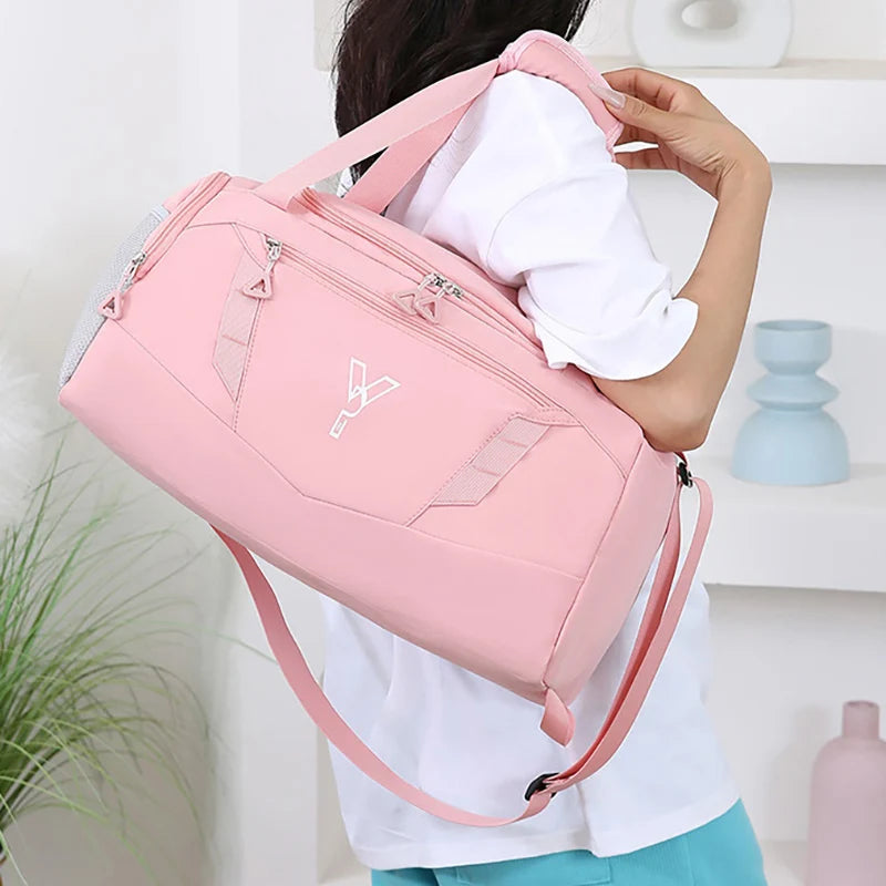 Person holding a pink duffel bag with a white background
