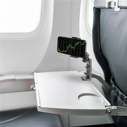 Foldable tray table with smartphone holder attached to an airplane seat