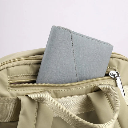 Gray wallet inside an open beige bag on a light gray background