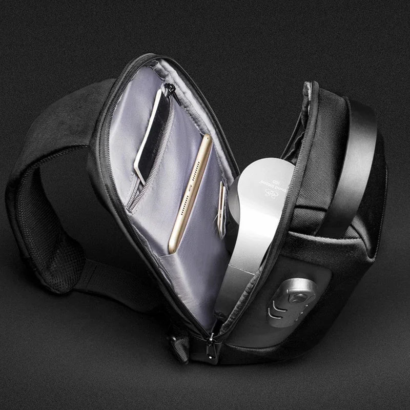 Black waist bag with a compartment for an Apple product on a dark background