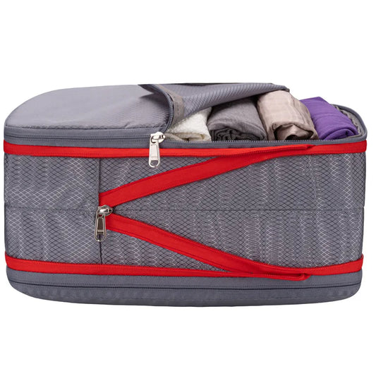 Gray packing cube with red zippers and clothes inside on a white background