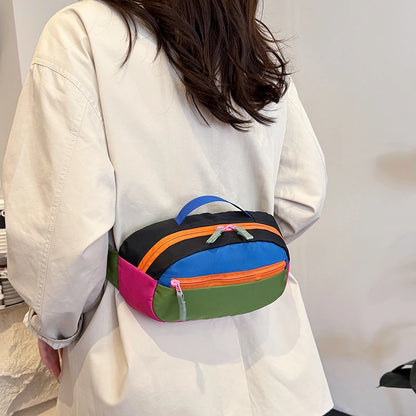 Person wearing a colorful waist bag with a plain background