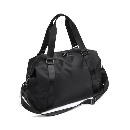 Black duffel bag with straps on a white background