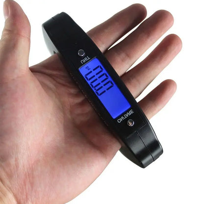 Digital luggage scale held in a hand with a white background