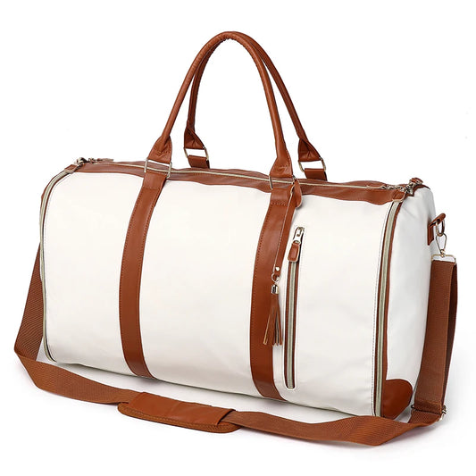 White duffel bag with brown leather straps and trim on a white background