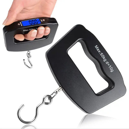 Digital luggage scale with a hand holding it on a white background
