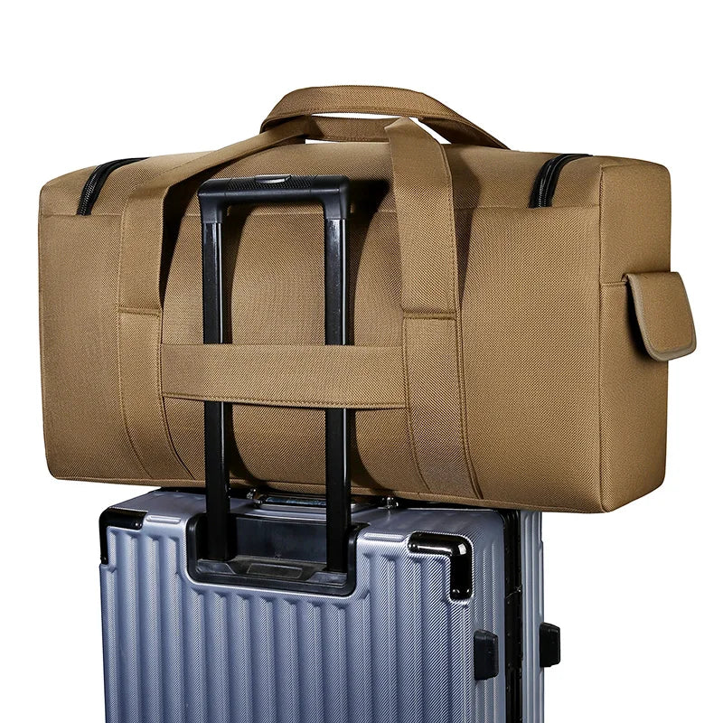 Brown duffel bag on top of a silver suitcase with a white background
