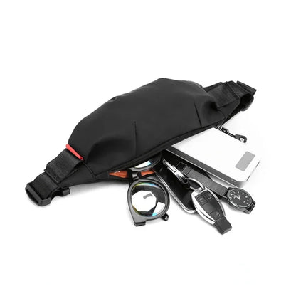 Black waist bag with various items including a phone, keys, and a watch on a white background