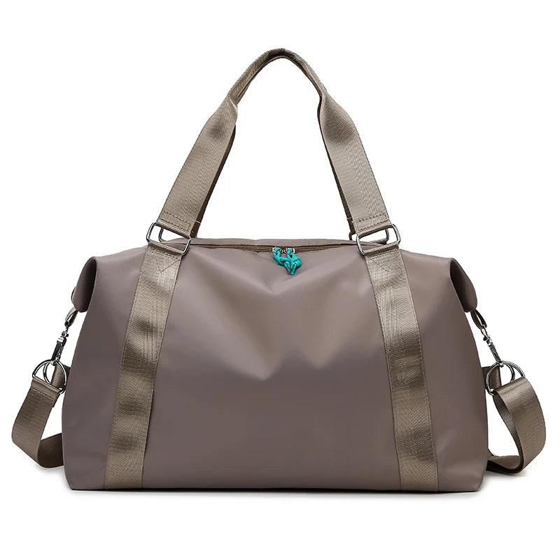Brown duffel bag with shoulder straps on a white background