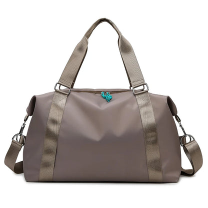Brown duffel bag with shoulder straps on a white background