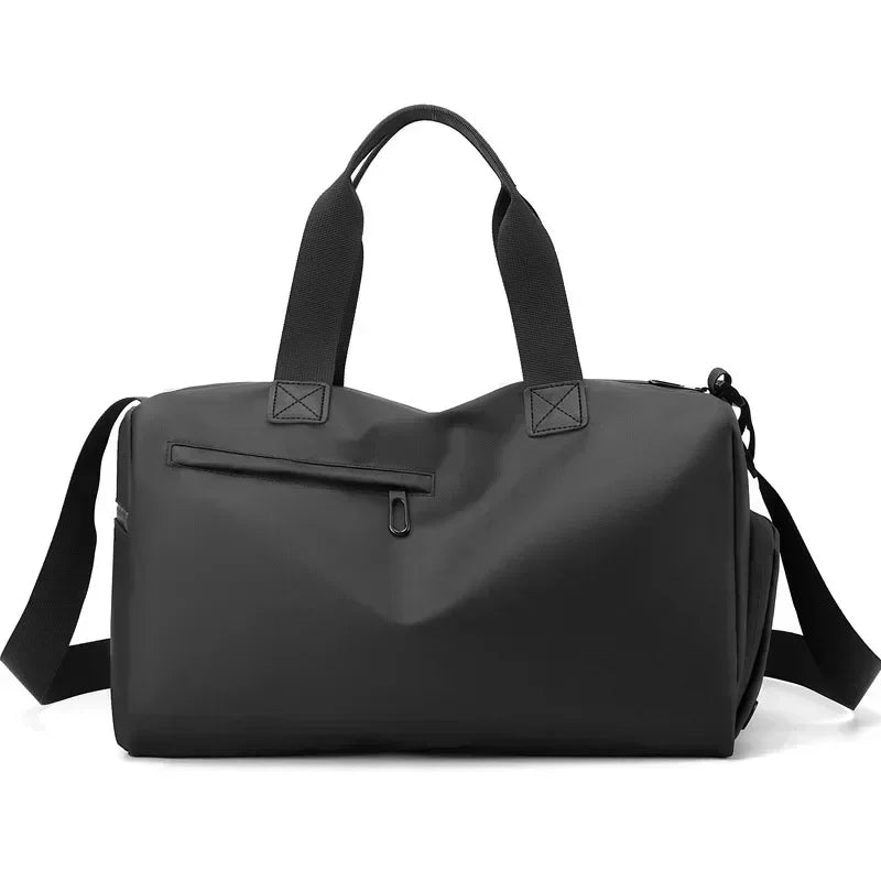 Black duffel bag with shoulder straps on a white background