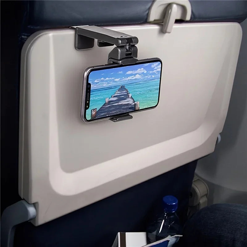 Phone mounted on a car seat headrest with a scenic view displayed.
