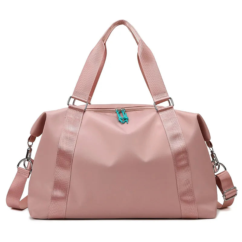 Pink duffel bag with a turquoise zipper on a white background