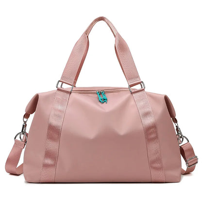 Pink duffel bag with a turquoise zipper on a white background
