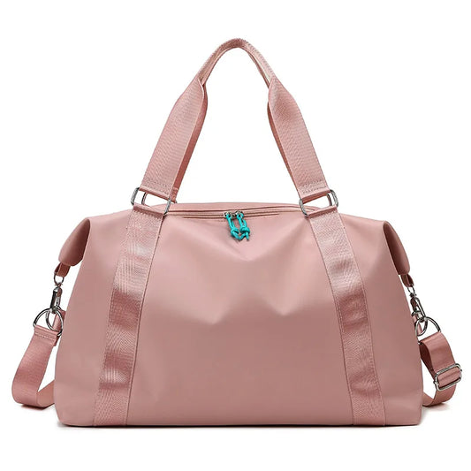Pink duffel bag with a turquoise zipper on a white background