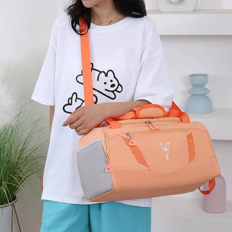 Person holding an orange duffel bag with a white background