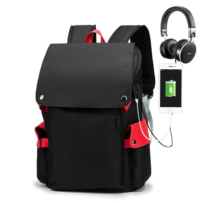 Black backpack with red accents, headphones, and a phone on a white background