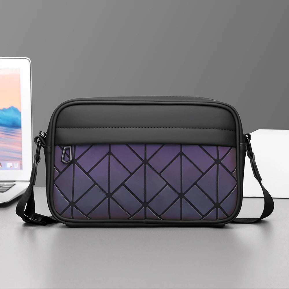 Black and purple geometric-patterned bag on a gray surface with a laptop in the background